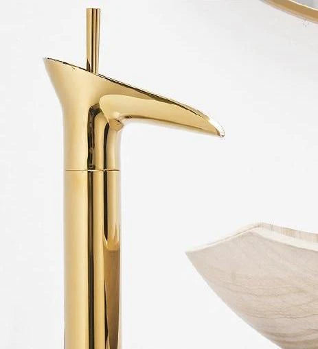 Stylish waterfall basin tap, elegant brass finish, bathroom decor accent.