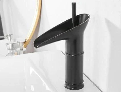 Luxury black waterfall basin mixer tap, modern deck-mounted faucet.