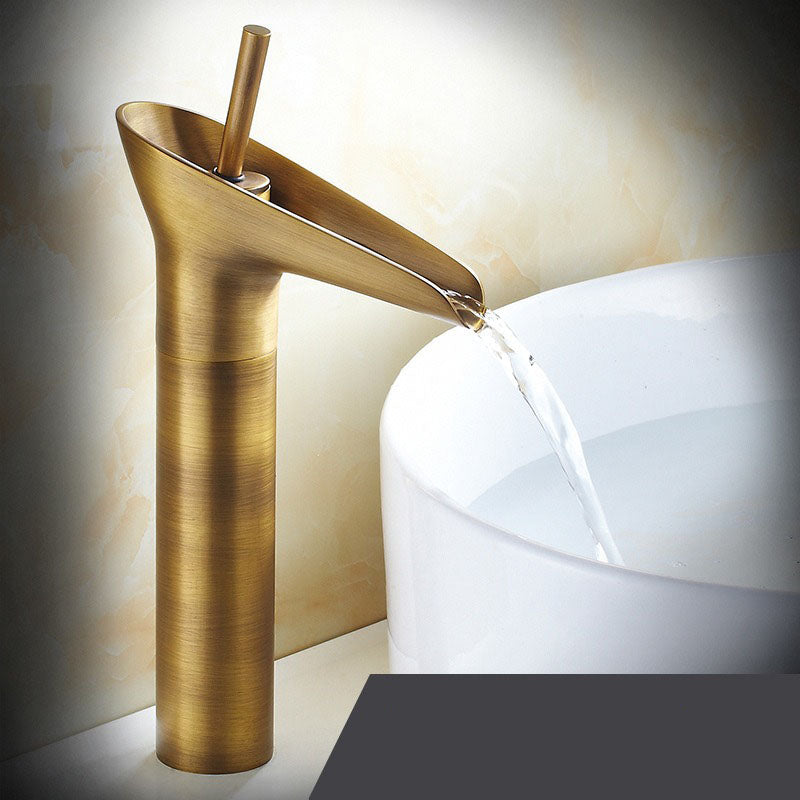 Antique brass waterfall basin faucet, vintage-inspired bathroom mixer tap.