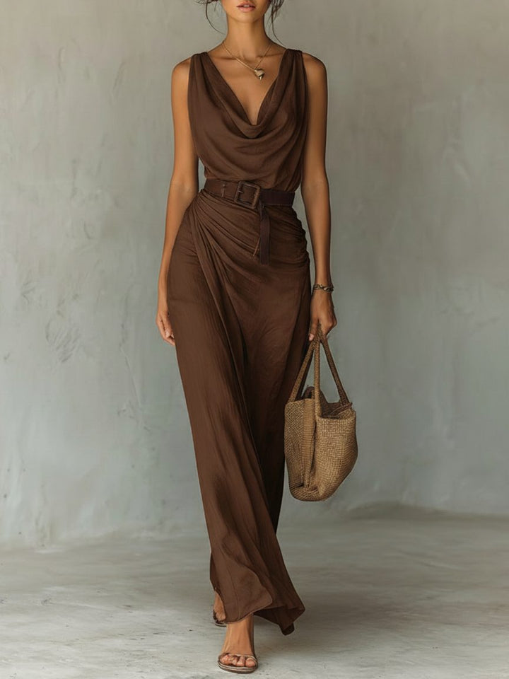 Elegant brown sleeveless maxi dress with a flattering cowl neck and stylish belt, perfect for summer evenings.