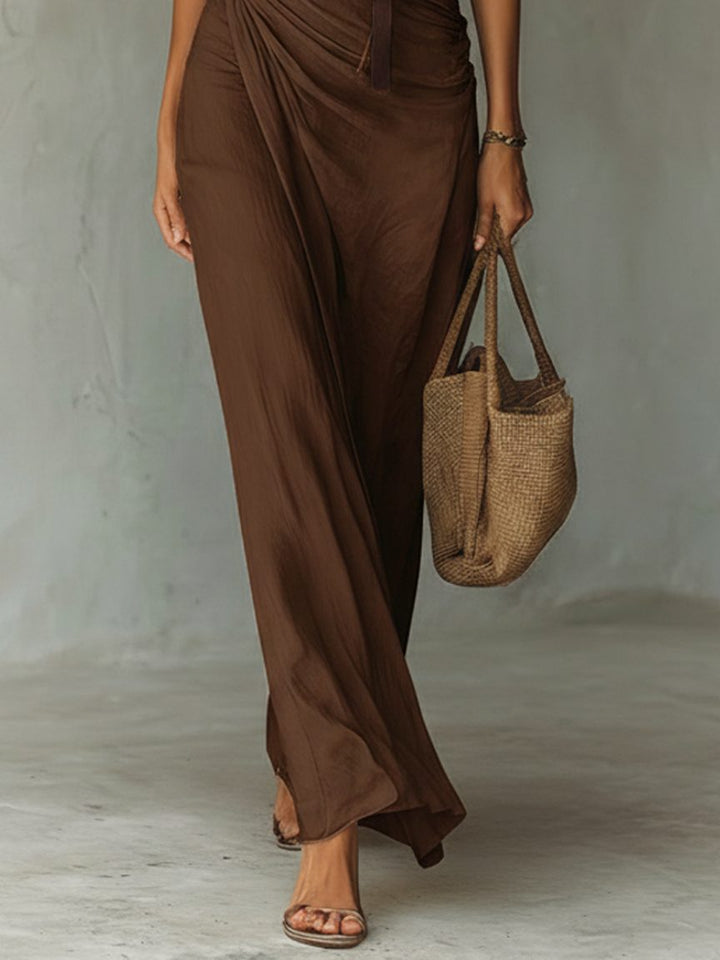 Versatile elegant brown sleeveless maxi dress with a graceful cowl neck and belt, perfect for casual to evening wear.