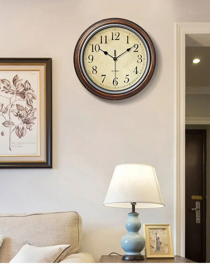 Elegant brown wall clock with classic Roman numerals. Silent round timepiece, perfect for living room or office decor.
