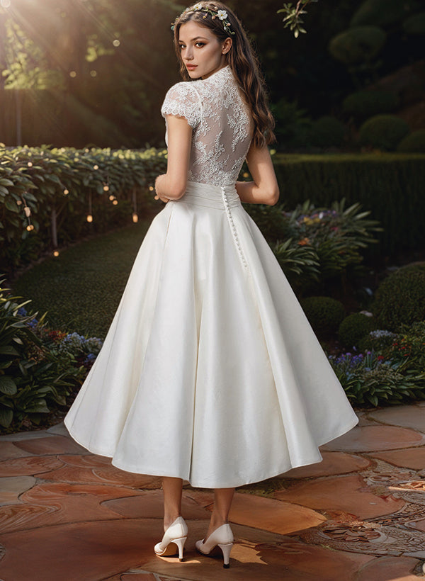 Beautiful Carmen vintage-style V-neck midi wedding dress crafted from delicate lace, ideal for a formal bridal occasion.