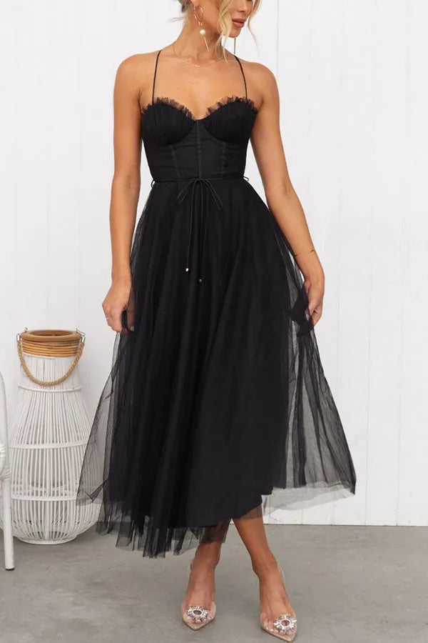 Delicate strap women's elegant midi dress, ideal for spring/summer wedding guests & parties.