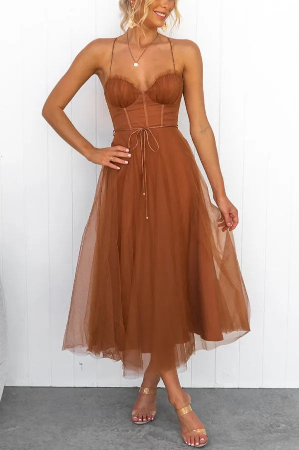 Elegant women's midi dress with corset detail and delicate straps, suitable for various formal events.
