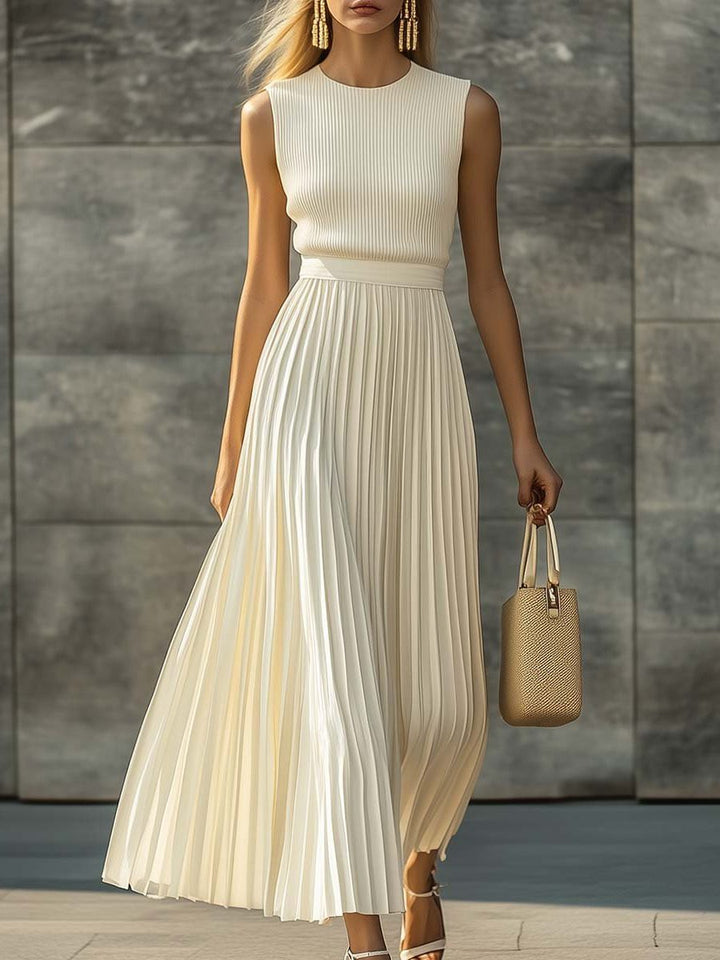 Elegant cream sleeveless pleated maxi dress for women. Perfect for formal events & parties. Sophisticated evening wear.