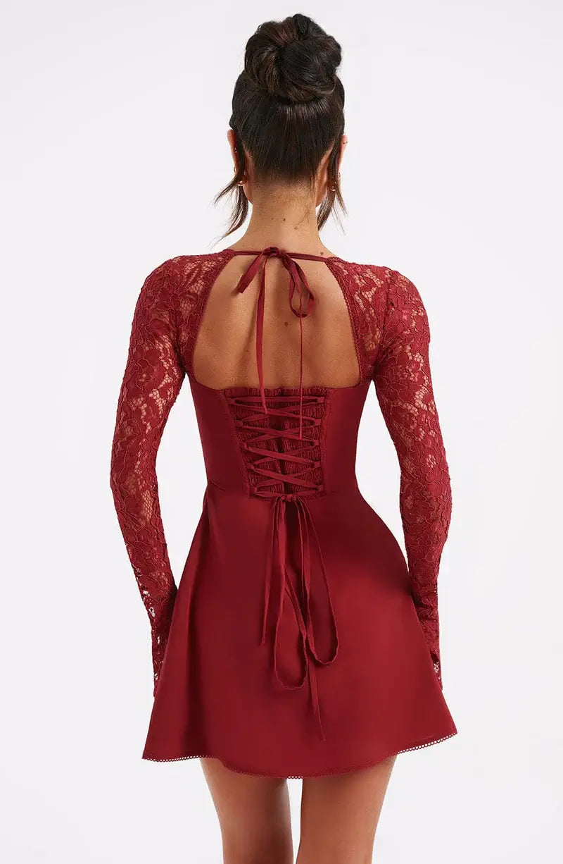 Detailed shot of elegant long lace sleeves on a women's fit & flare mini party dress.