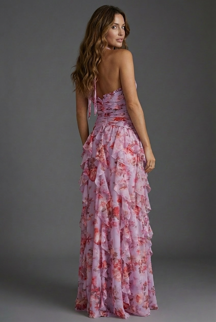 Chic women's floral halterneck maxi dress with cascading ruffles, ideal for elegant occasions & vacations.