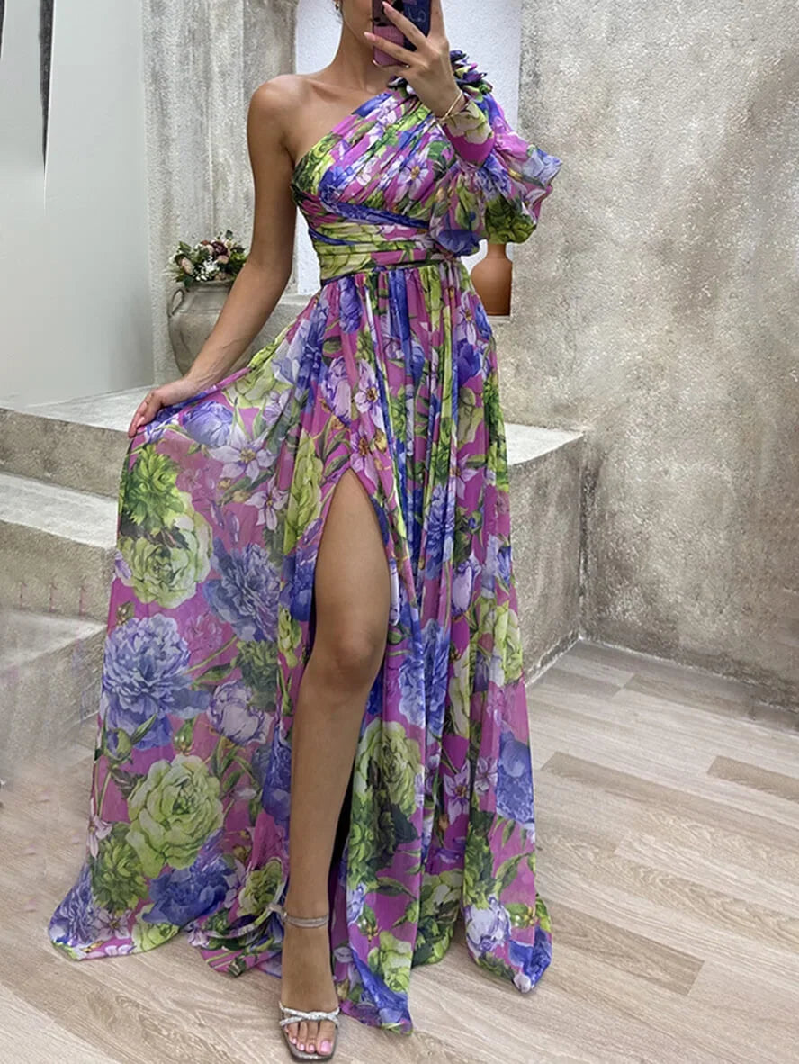 Chic floral one-shoulder maxi dress with a high slit & puff sleeve for women. Elegant summer party attire.