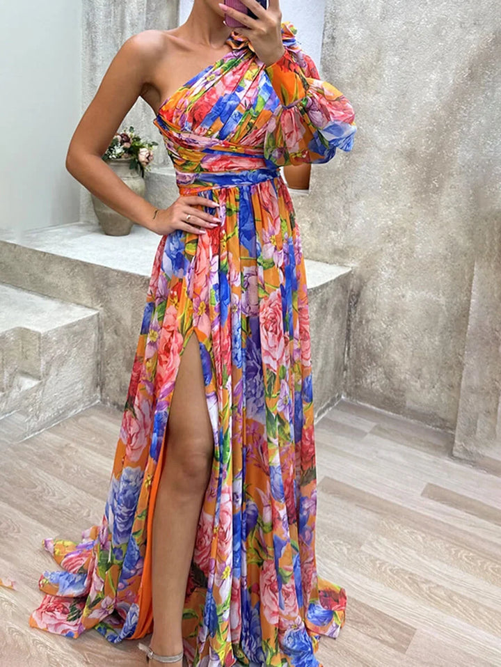 Beautiful floral one-shoulder women's maxi dress with an alluring high slit & fashionable puff sleeve detail.