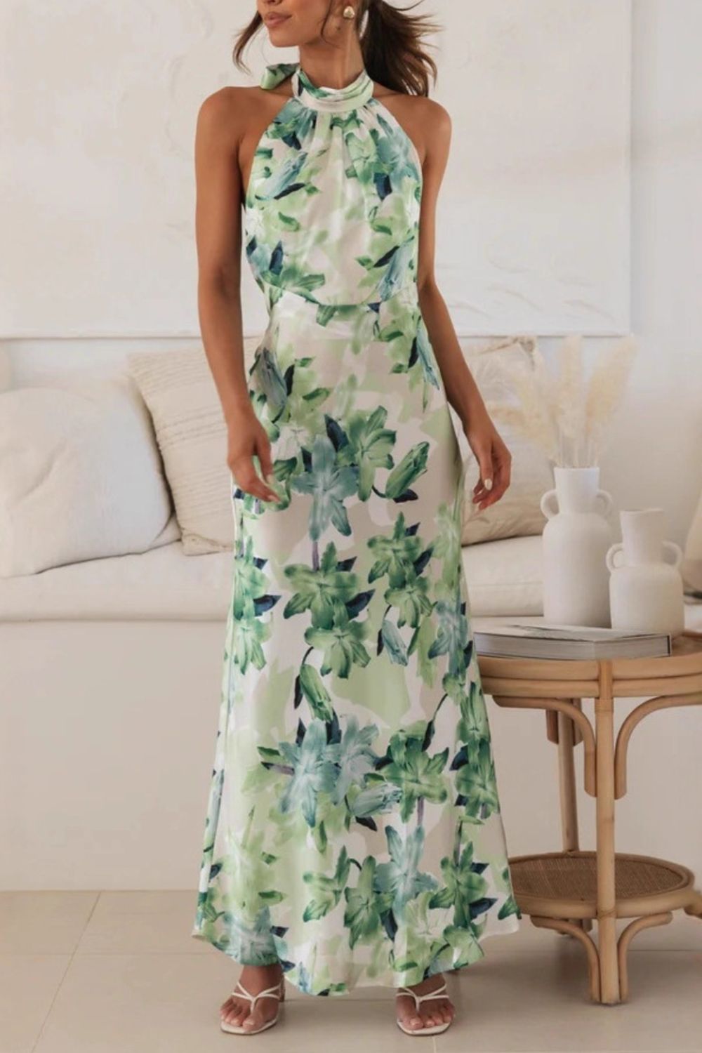 Stunning floral print formal dress with a halter neck and a sweeping floor-length silhouette.
