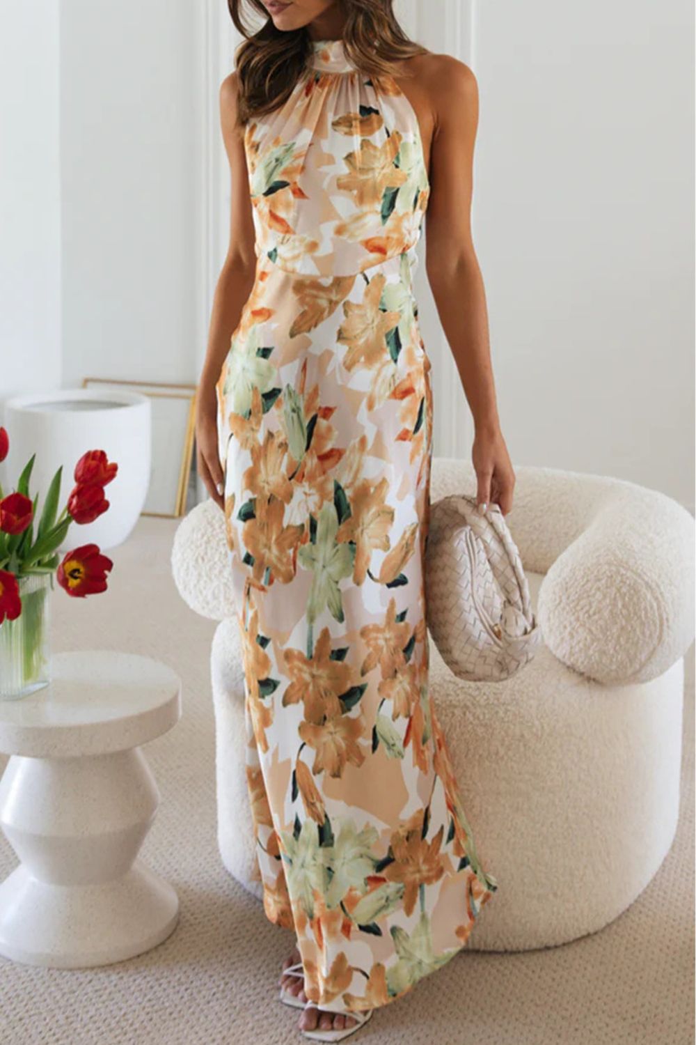 Floor-length floral print evening gown with a halter neckline and an eye-catching slit.
