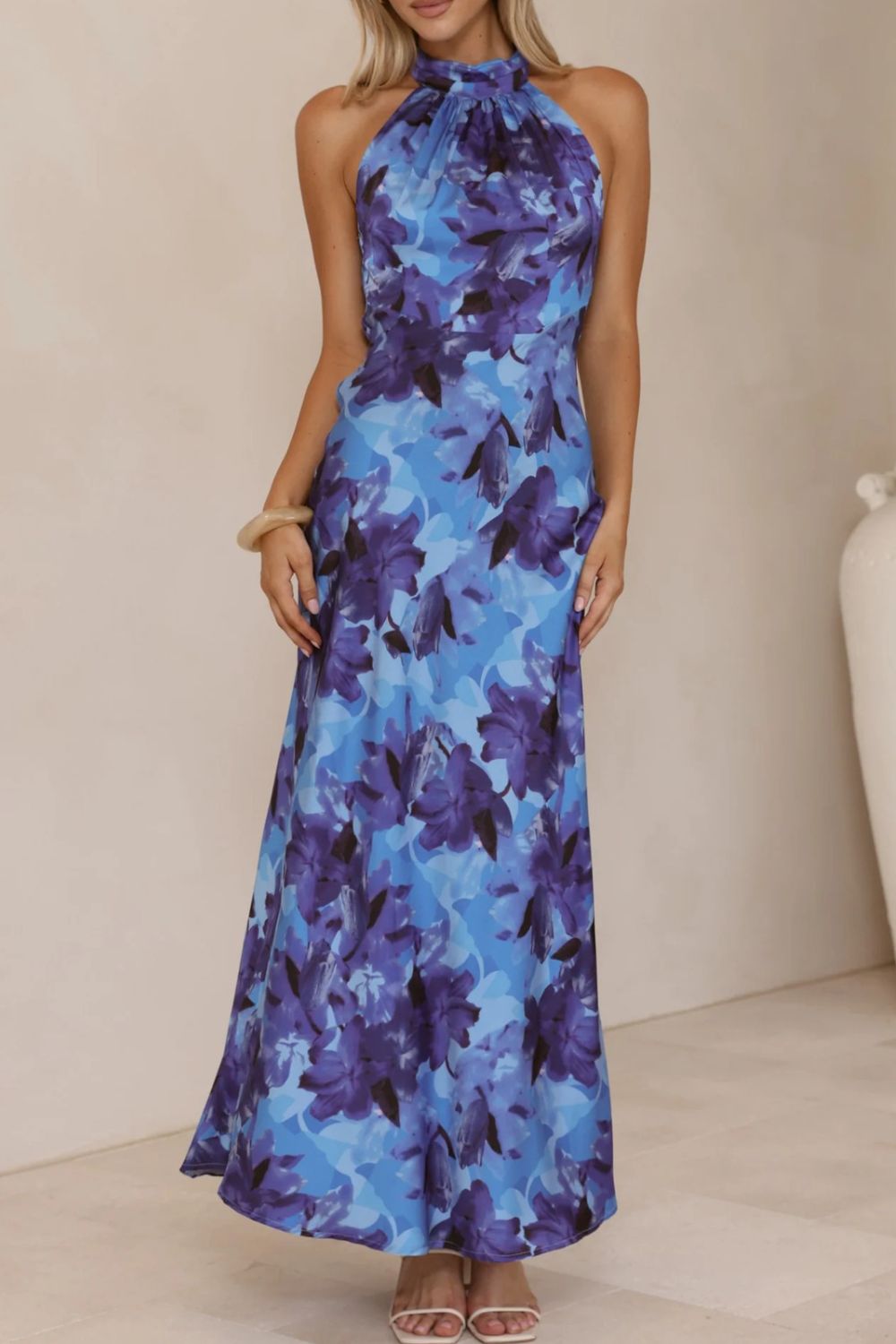 Modern floral print dress with a halter neckline and a chic, ankle-grazing slit.
