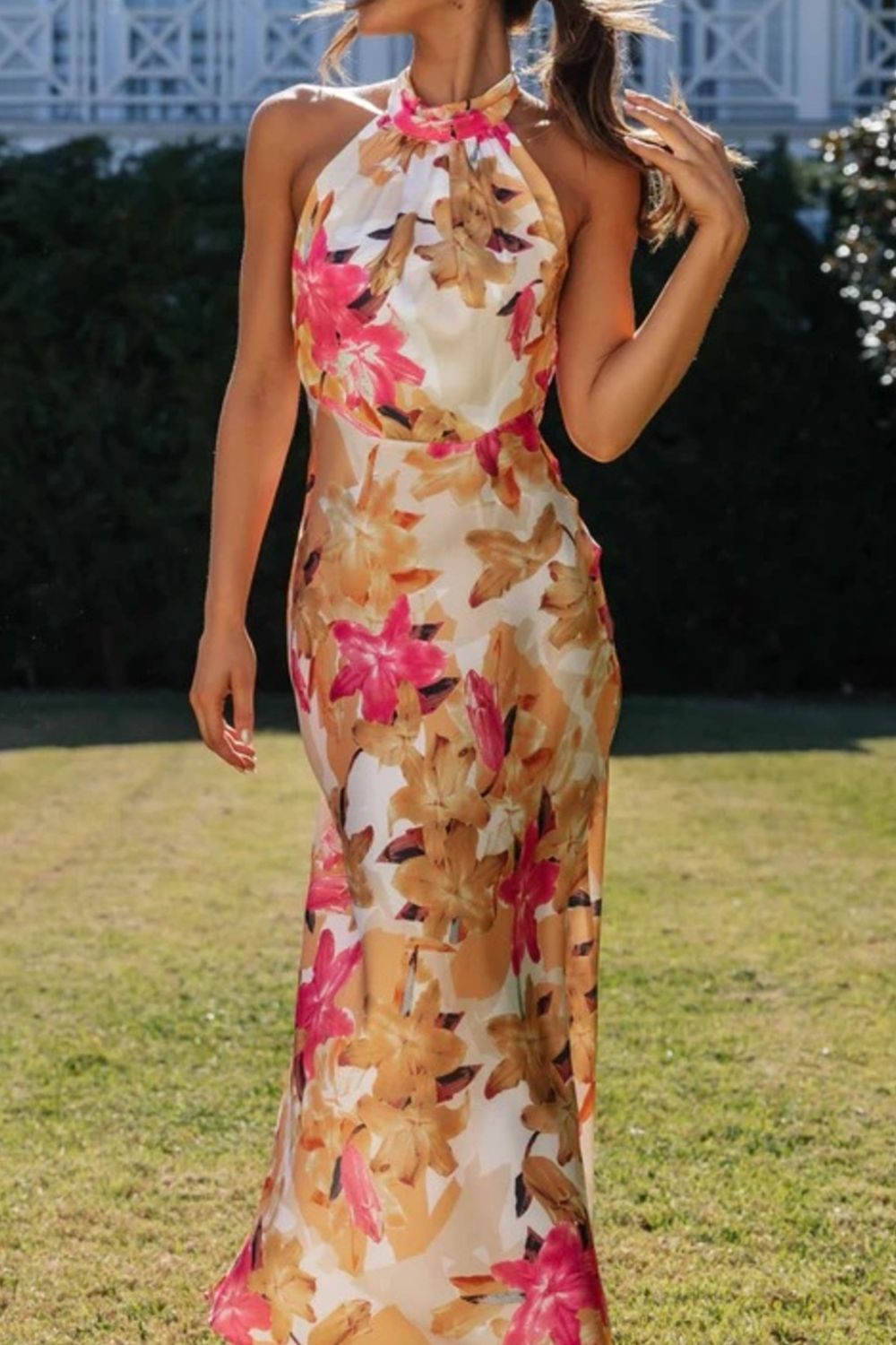 Chic floral halter dress featuring a dramatic leg slit, ideal as a formal evening gown.