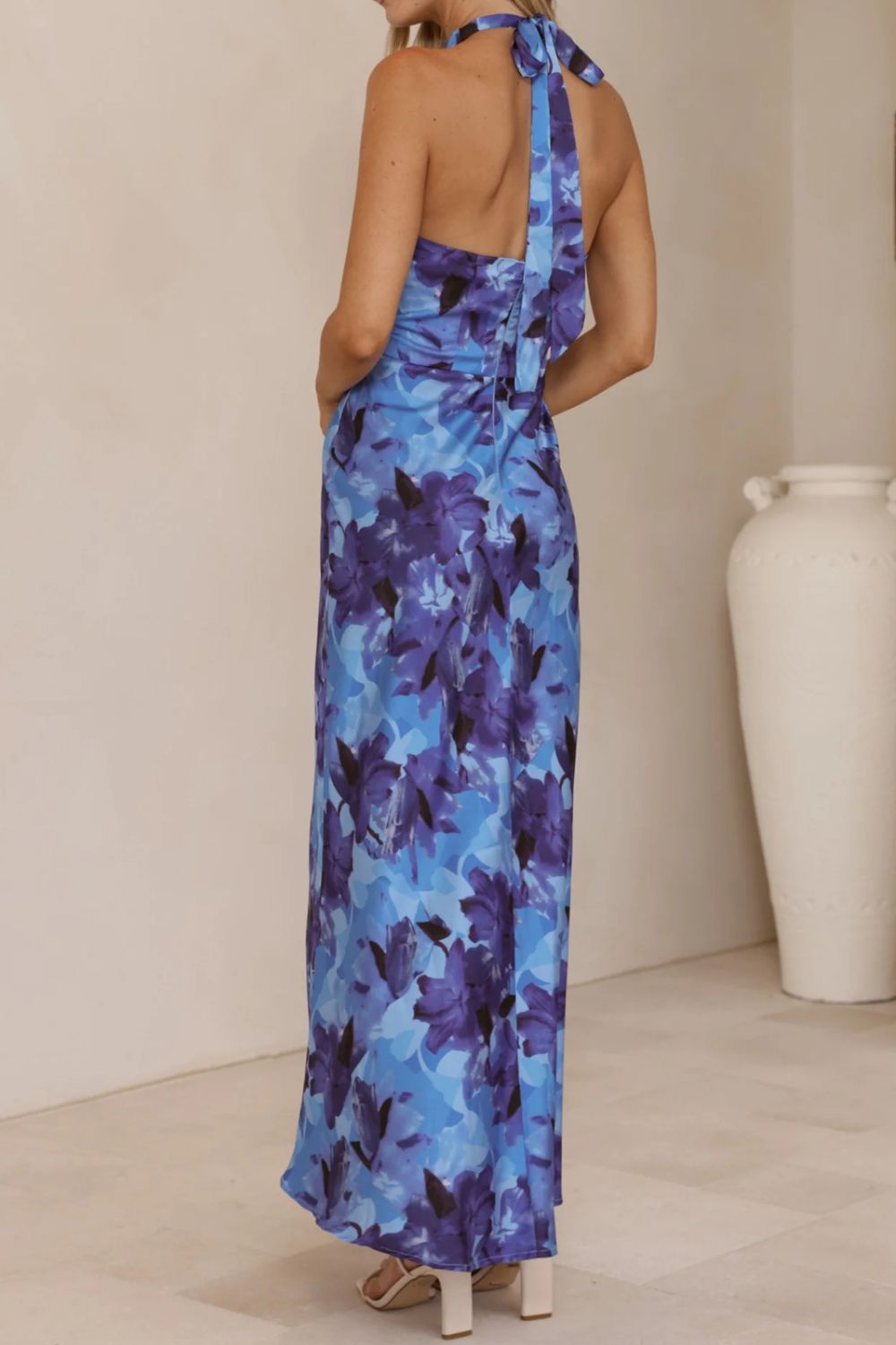 Glamorous floral evening gown with a halter top and a sophisticated, floor-sweeping slit.