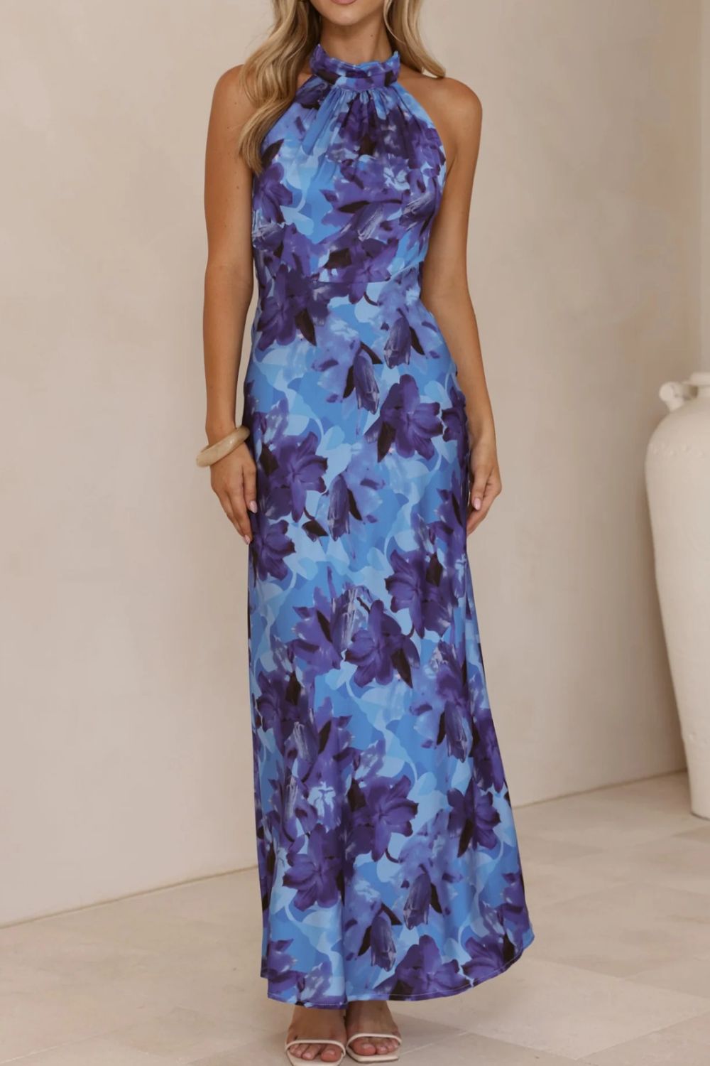 Beautiful floral print wedding guest dress with a halter neckline and a daring slit.