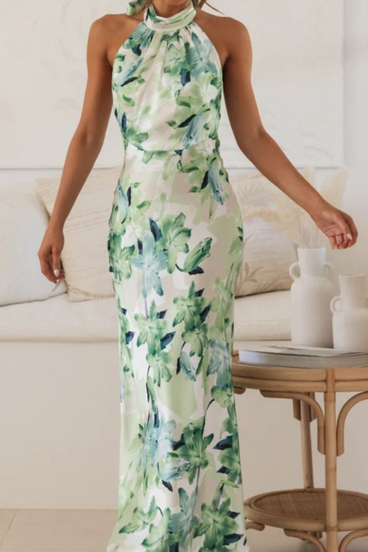 Bohemian-inspired floral halter dress, floor-length with a graceful slit for wedding events.