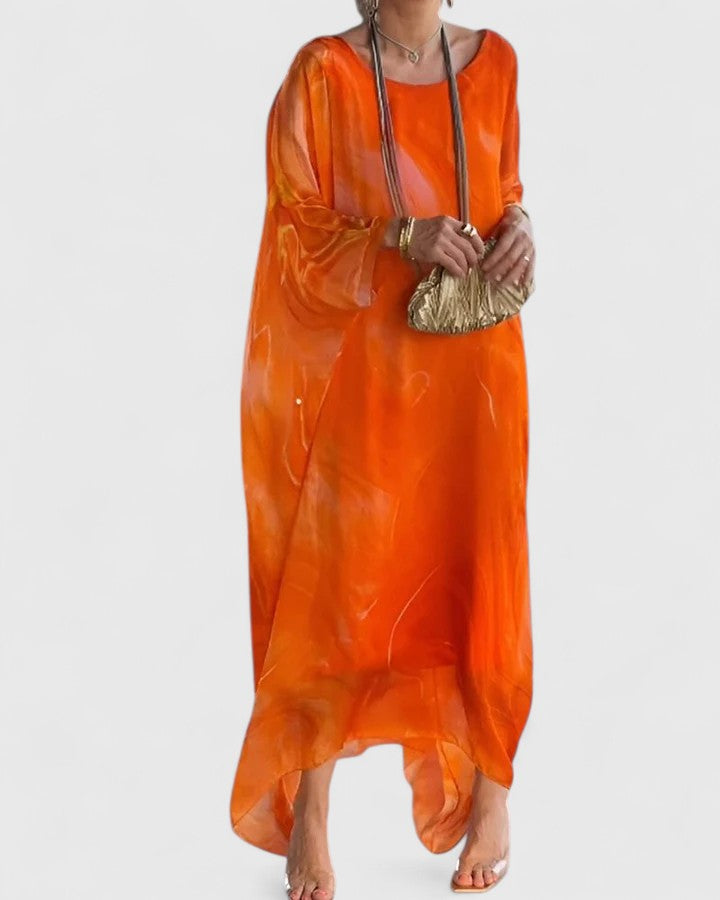 Woman gracefully posing in an elegant flowy maxi dress, perfect for weddings, parties, or special evenings.