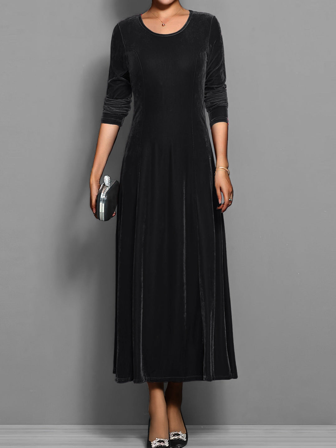 Graceful women's full-length flared maxi dress, long sleeves, round neck, offering an elegant silhouette.