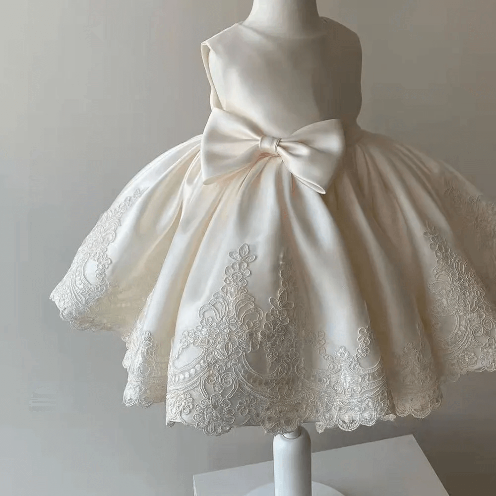 Sparkling Aurora Princess Gown for girls, featuring delicate lace sleeves and a charming bow accent, ideal for birthdays and formal events.
