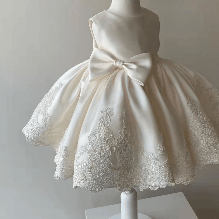 Sparkling Aurora Princess Gown for girls, featuring delicate lace sleeves and a charming bow accent, ideal for birthdays and formal events.