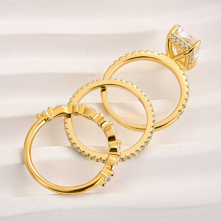 Three-piece bridal jewelry set featuring gold finish wedding rings