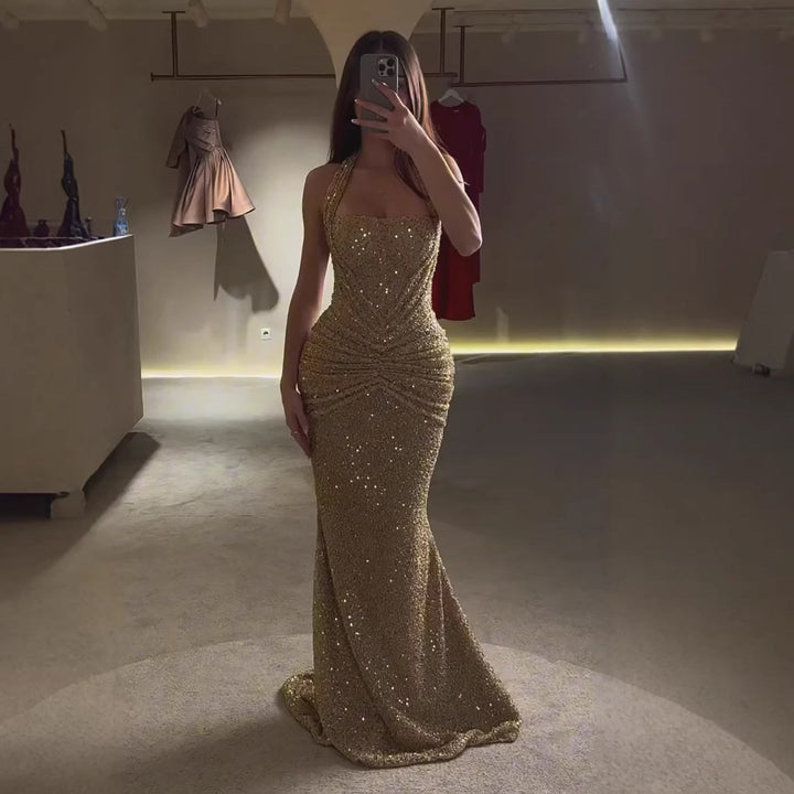 Women's elegant gold halter formal maxi dress. Perfect special occasion evening gown for a sophisticated look.