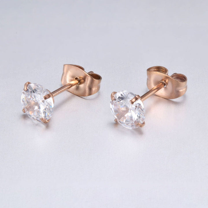 Fashionable gold earrings with pave-set sparkling stones, women's accessory.