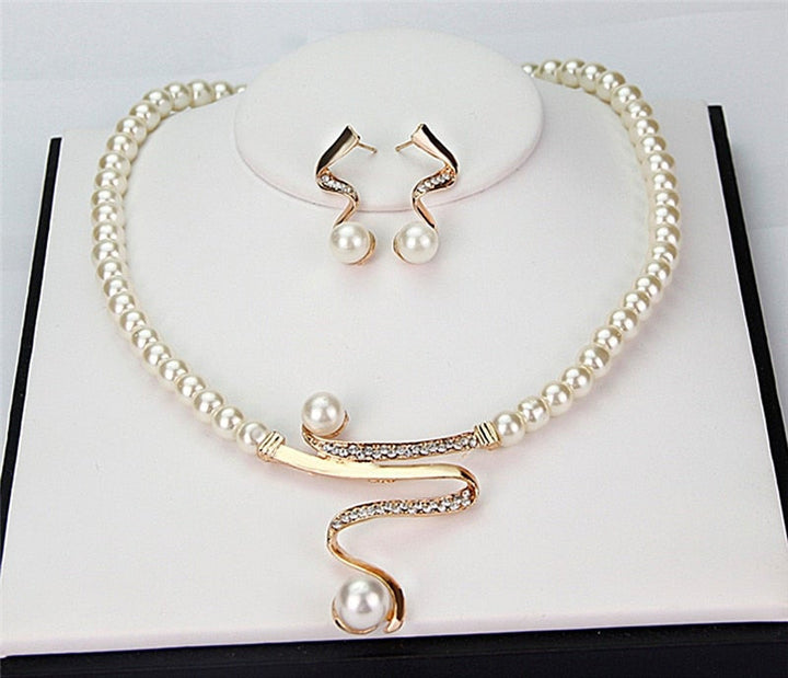 Close-up of a women's classic gold necklace and matching earrings. Timeless elegant jewelry set, ideal for gifts.