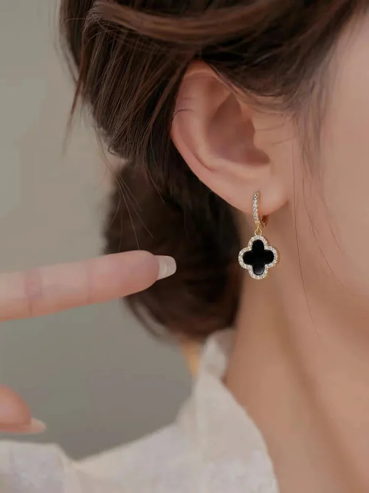 Chic green crystal clover leaf earrings for women. Gold-plated lucky charm, perfect for everyday elegance.