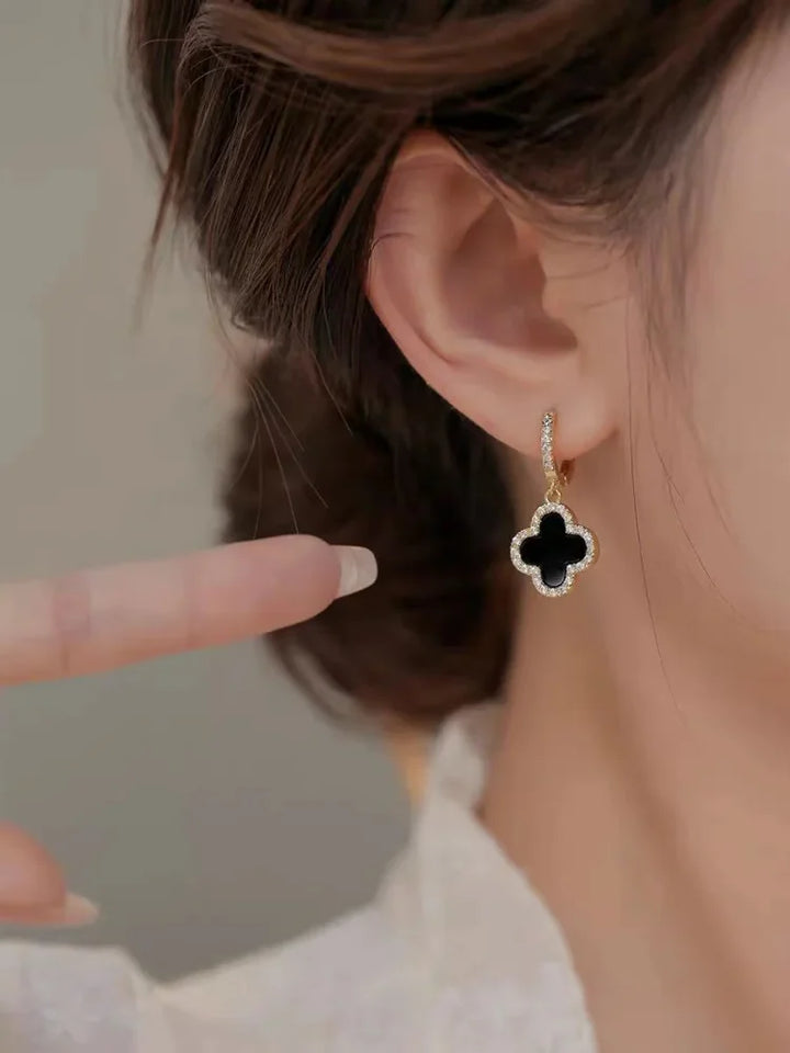 Chic green crystal clover leaf earrings for women. Gold-plated lucky charm, perfect for everyday elegance.