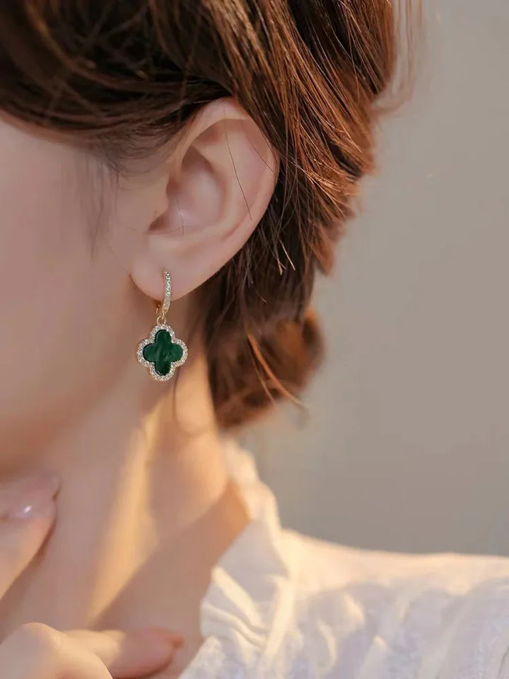 Stylish black crystal clover leaf earrings, gold plated. Women's lucky charm jewelry, elegant fashion accessory.