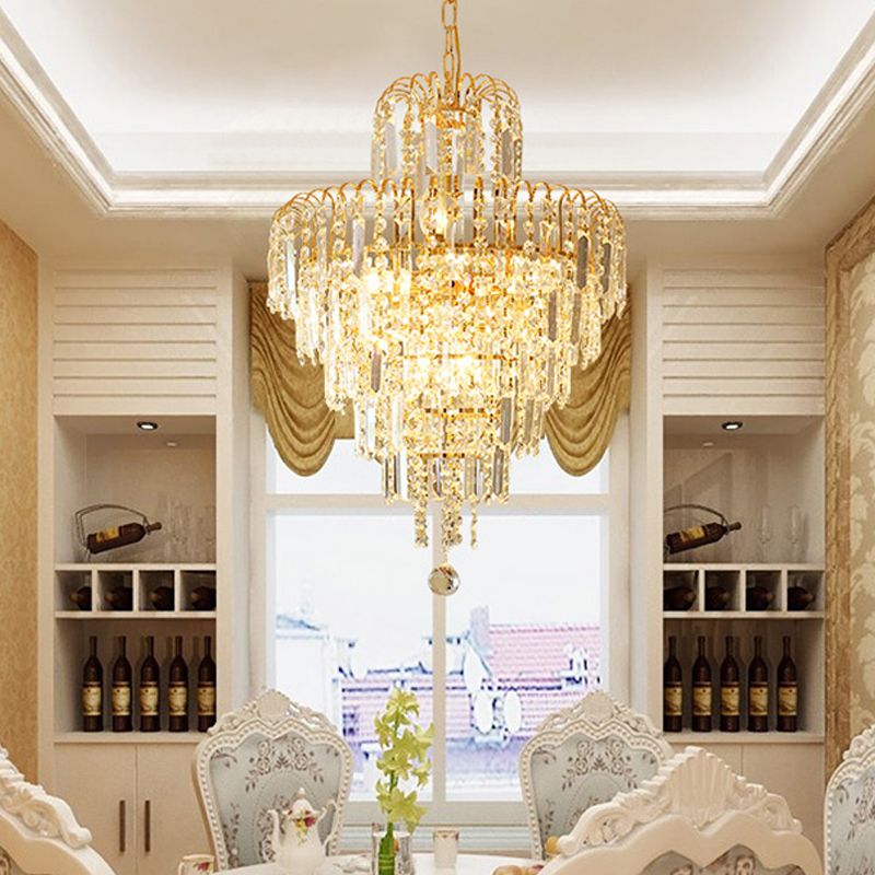 Radiant gold finish tiered crystal chandelier, adding glamour and luxury to any interior space.