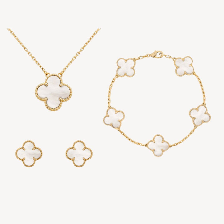 Women's gold-tone clover jewelry set featuring multi-color options: necklace, bracelet, and earrings.