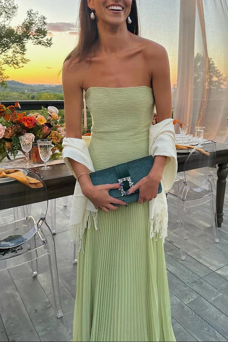 Women's green pleated strapless maxi dress, an elegant choice for wedding guest attire.