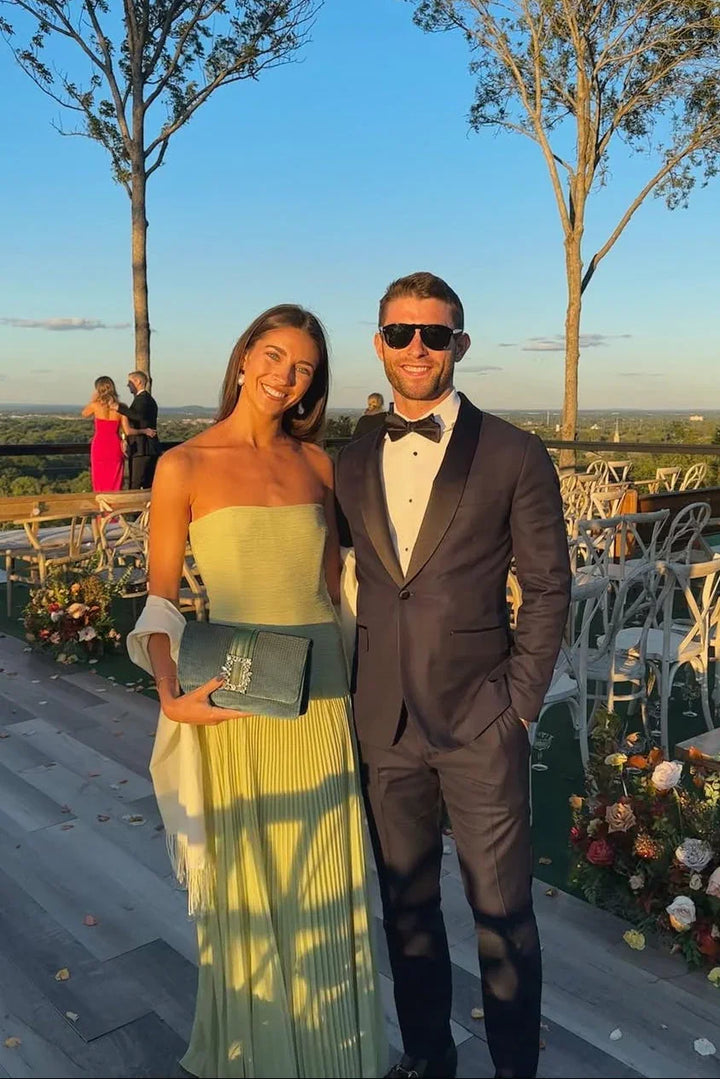 Stylish women's green strapless pleated maxi dress, a sophisticated party dress for wedding guests.