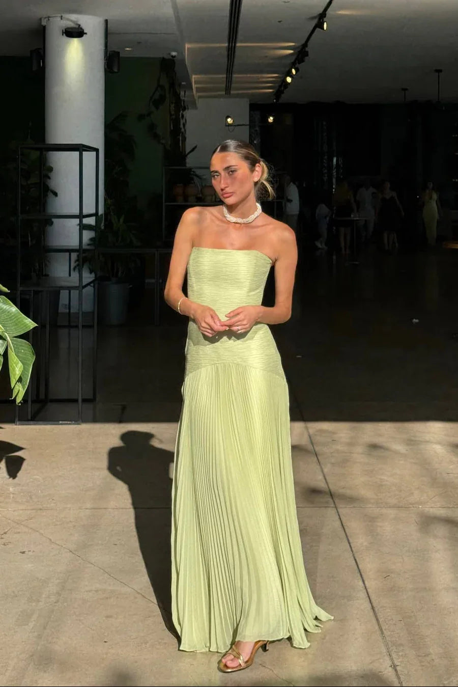 Elegant women's green strapless pleated maxi dress with a flattering silhouette for formal events.