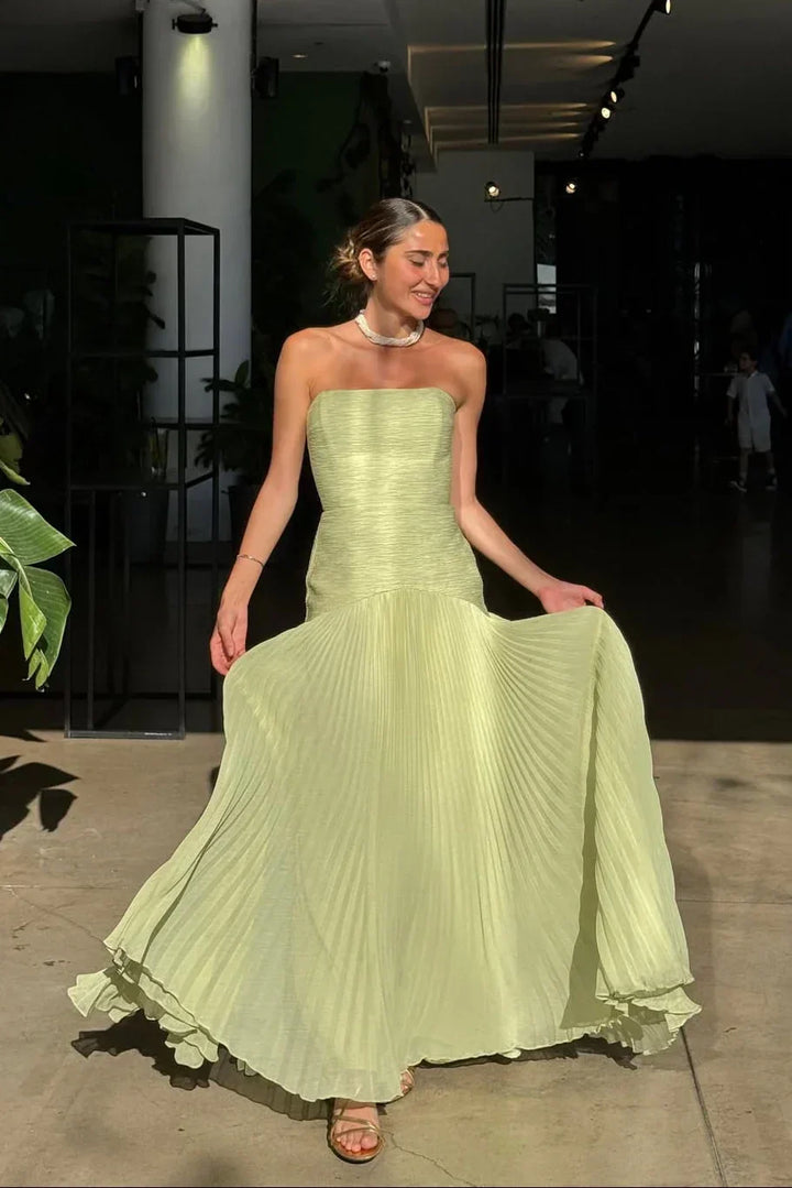 Beautiful green strapless maxi dress for women, featuring elegant pleats, perfect for evening wear.