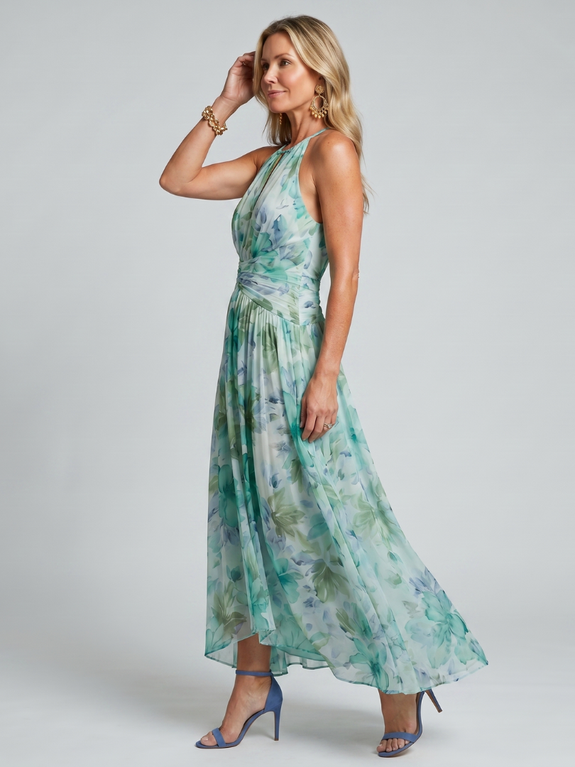 Sleeveless green floral midi dress featuring a stylish halter neckline and keyhole detail. Flowy pleated skirt.