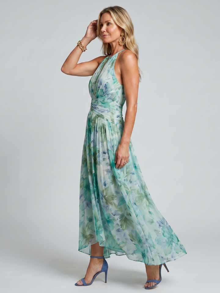 Sleeveless green floral midi dress featuring a stylish halter neckline and keyhole detail. Flowy pleated skirt.
