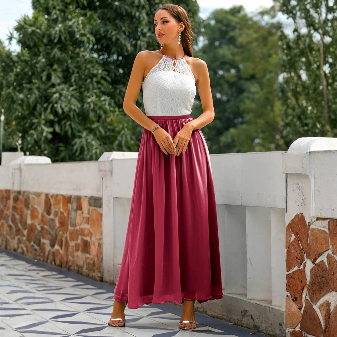 Flowing women's halter neck maxi gown, ideal as a sophisticated formal evening dress or wedding guest attire.