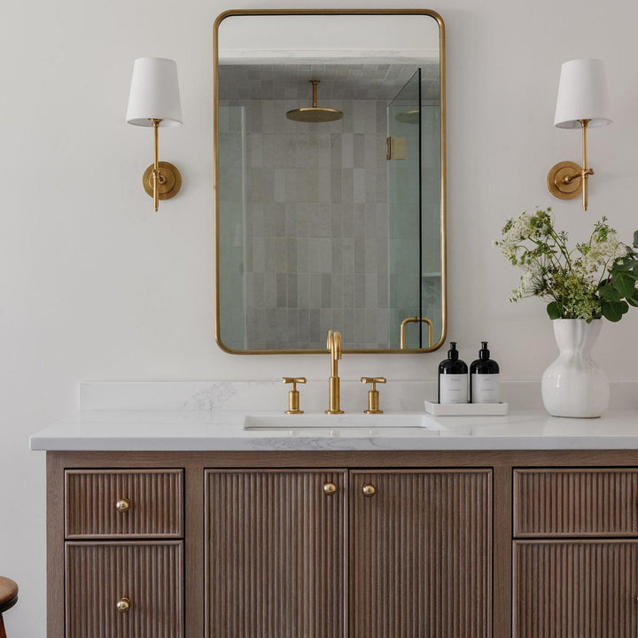 Brushed nickel wall sconce with a rectangular fabric shade, ideal for living room.