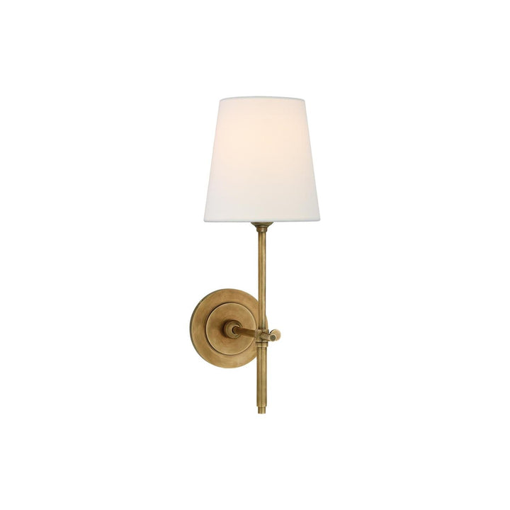 Sophisticated wall sconce with cream fabric shade, perfect for bedroom ambiance.