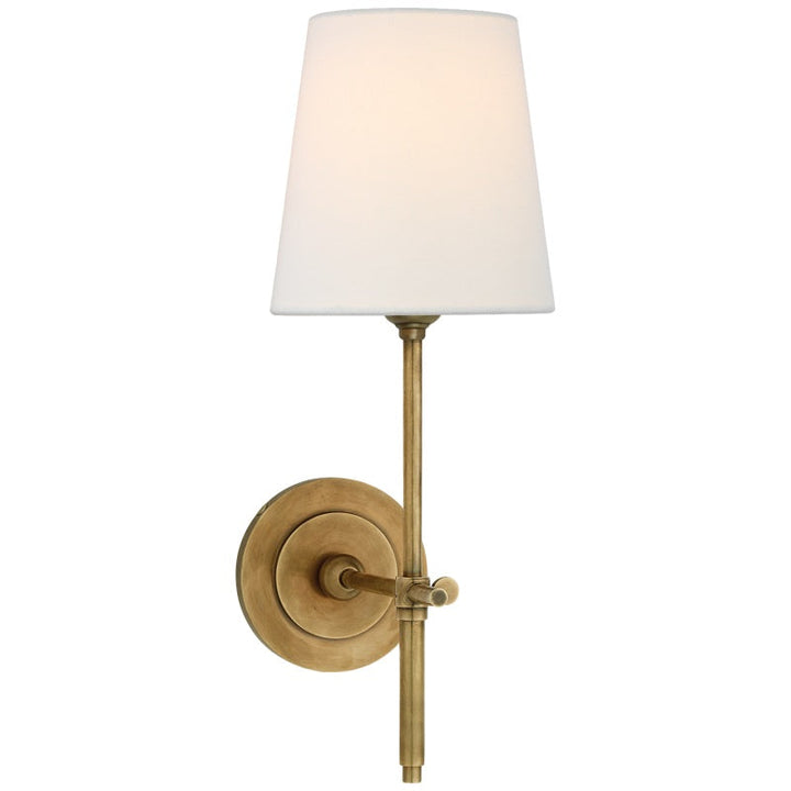 Living room wall lamp, hardwired, with a fabric shade, offering warm ambient light.