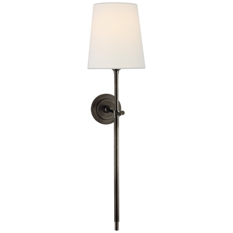 Diffused ambient lighting via an indoor wall lamp with a linen fabric shade.
