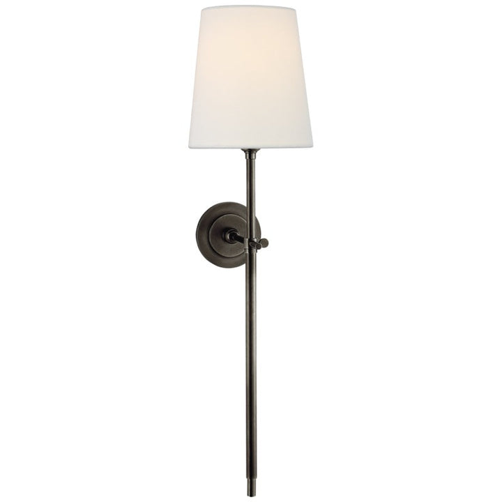 Diffused ambient lighting via an indoor wall lamp with a linen fabric shade.