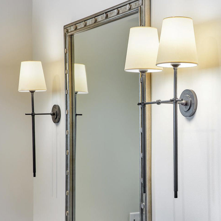 Stylish wall lamp with a linen-texture fabric shade, creating a warm, inviting glow.