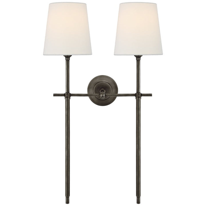Functional hardwired wall lamp with an elegant fabric shade for soft, even room illumination.