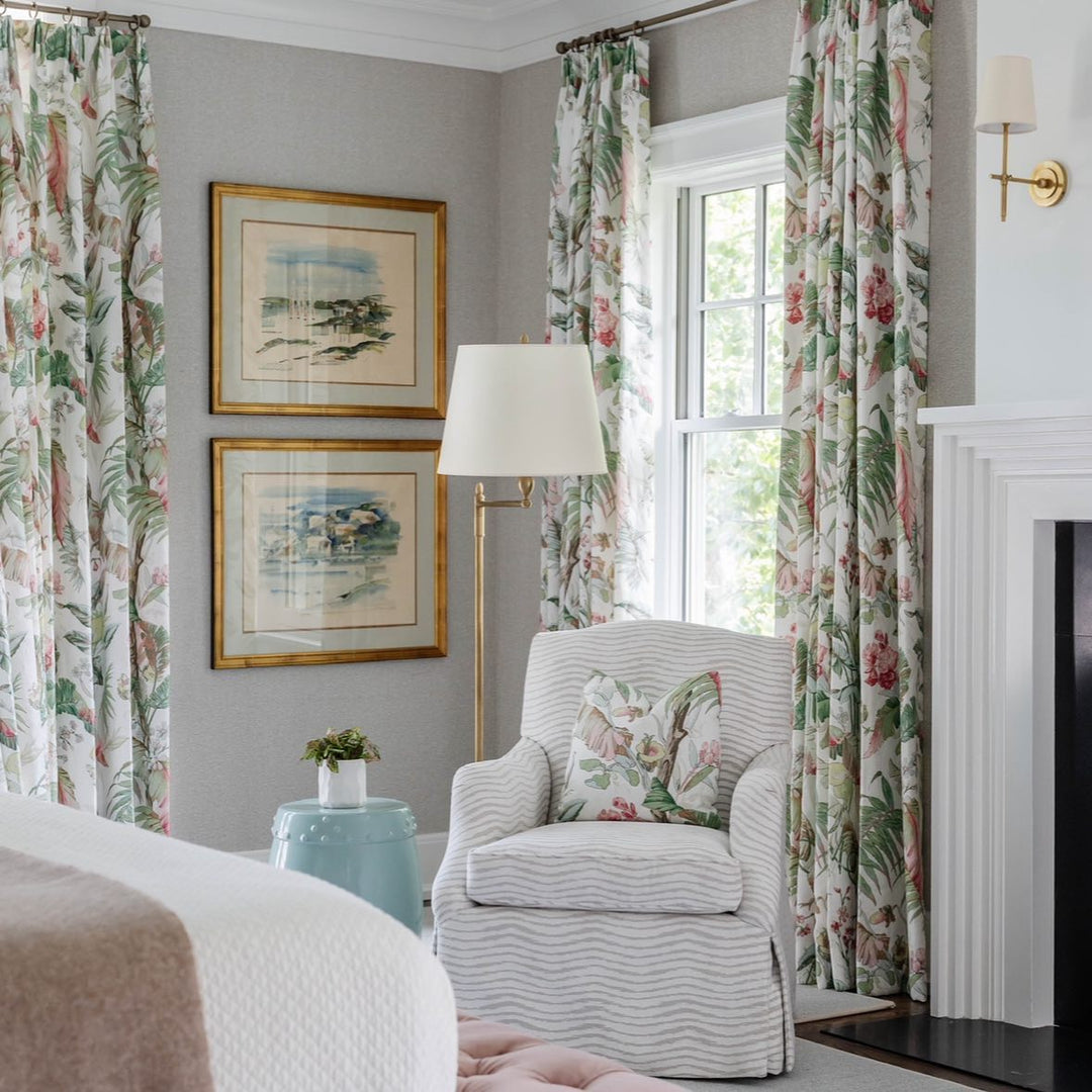 Chic wall sconce with a neutral fabric shade & sleek metal finish for modern interiors.