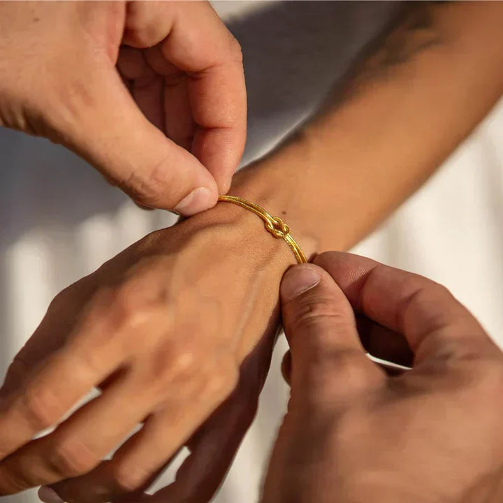 Gold-tone elegant knot bracelet for women, a stylish minimalist fashion accessory.